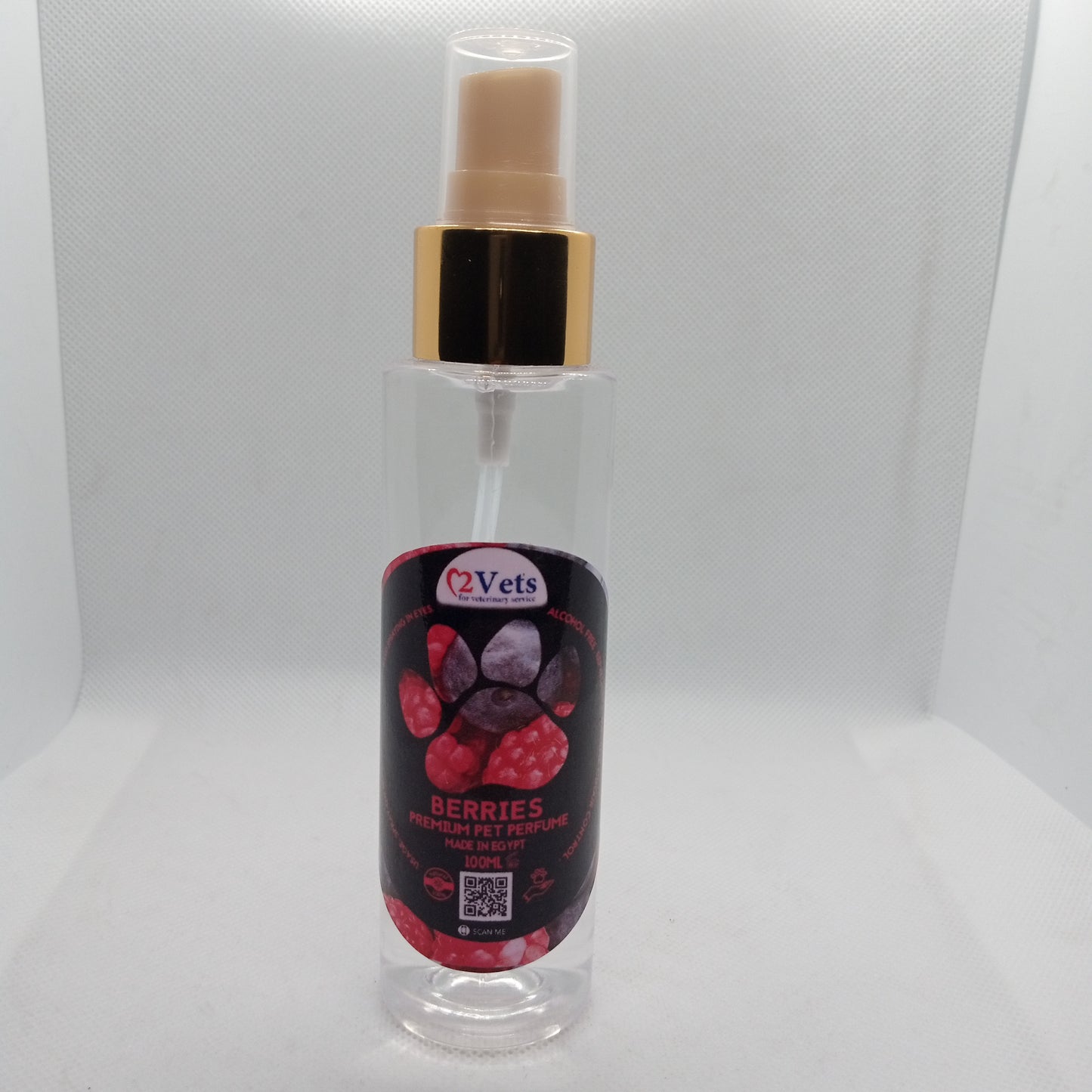 Clear spray bottle with black label featuring berries on a white background