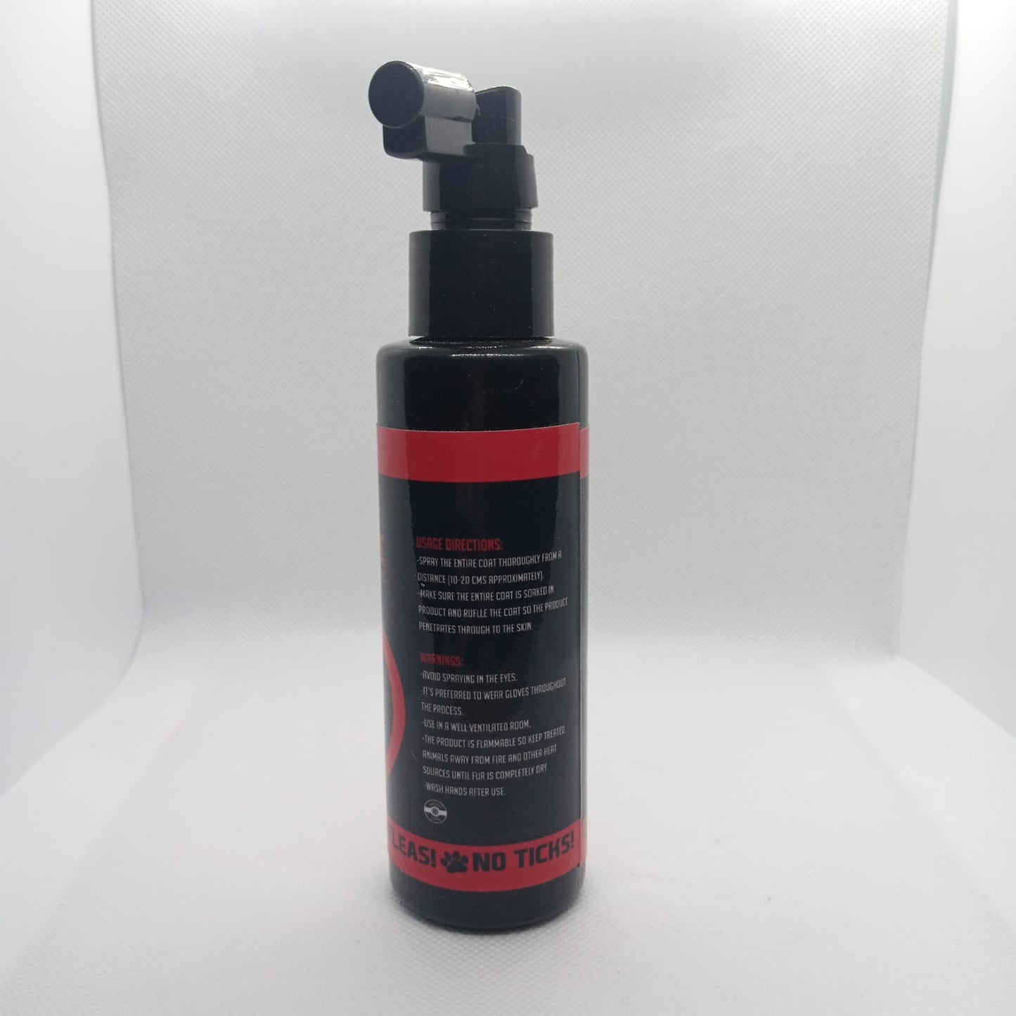 Black and red bottle with pump on a white background