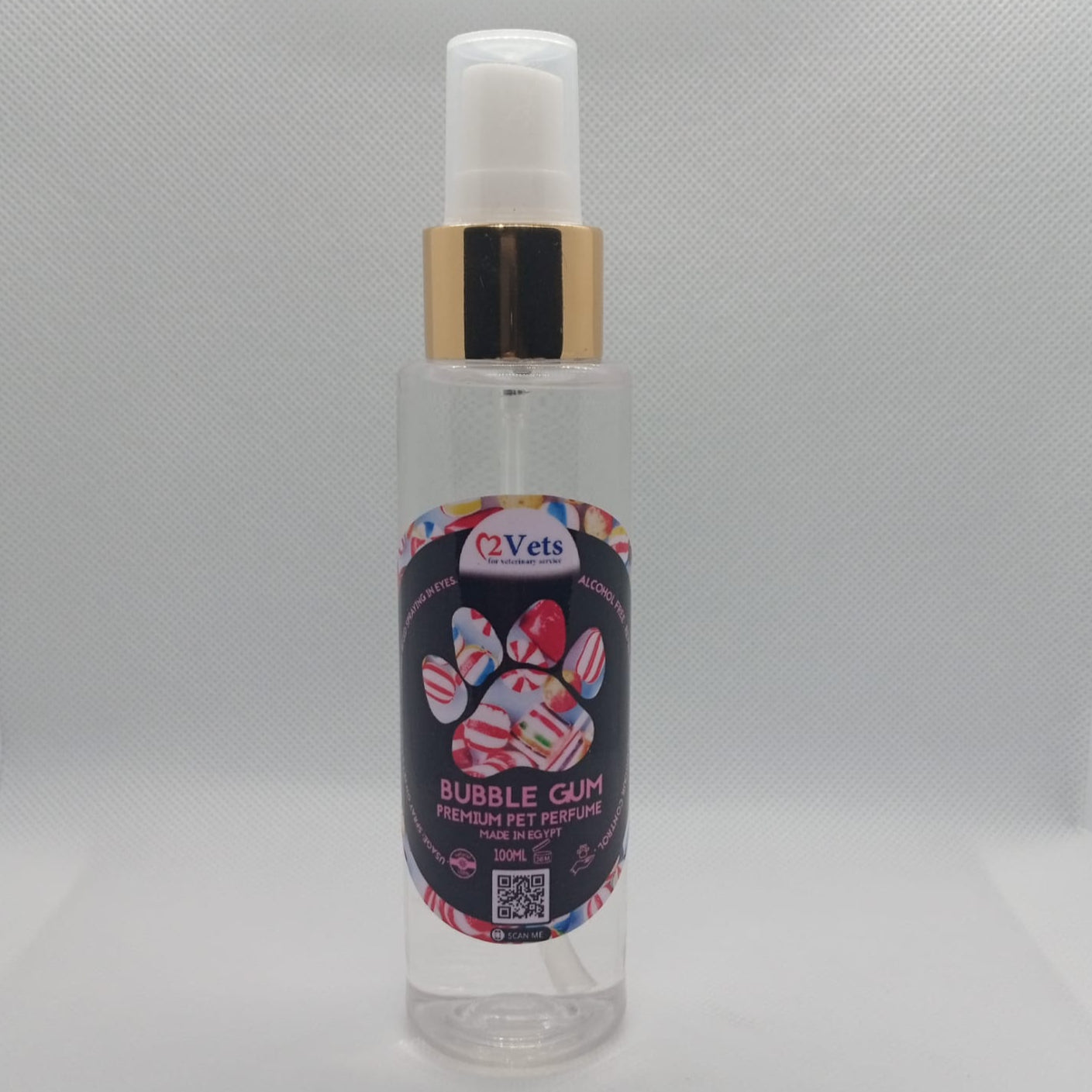Clear spray bottle with colorful label on a gray background