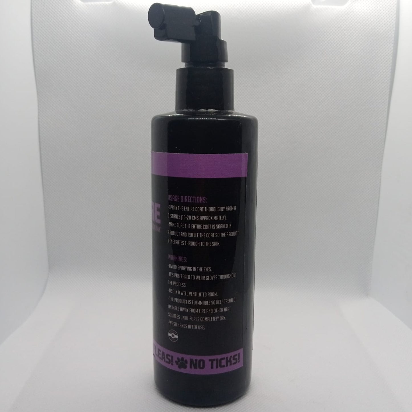 Black bottle with purple label on a white background