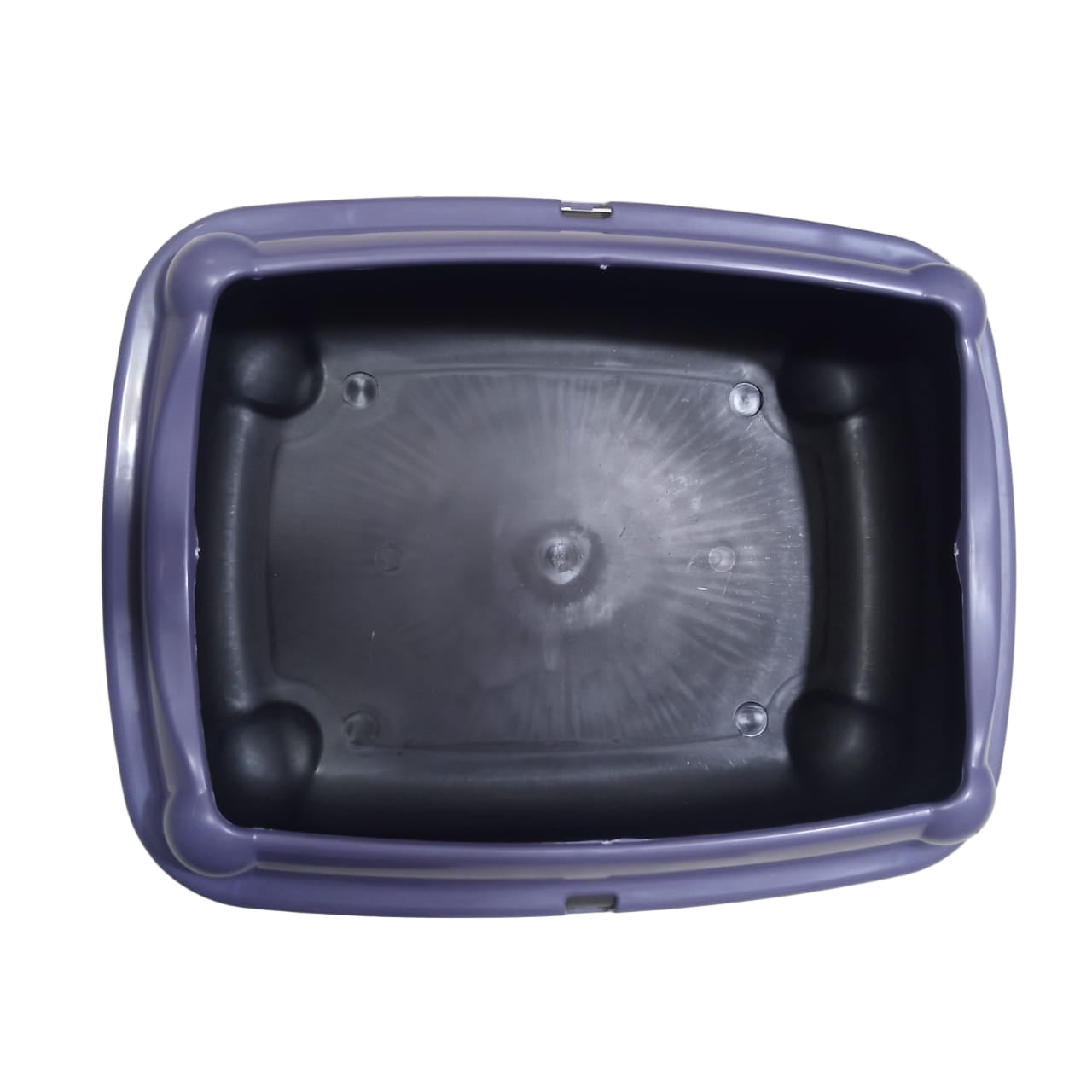Black plastic container with purple lid on a tiled floor