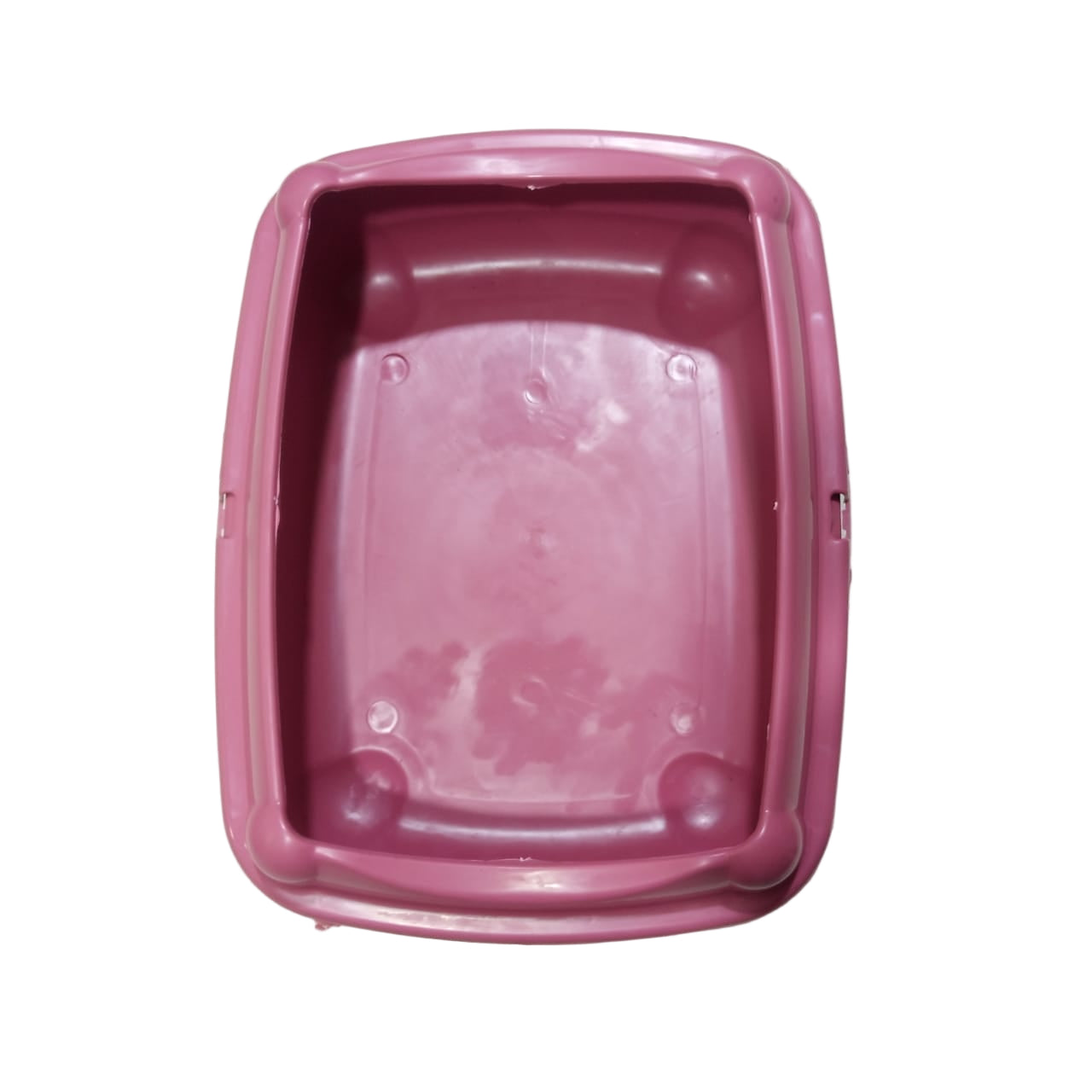 Pink plastic container on a tiled floor