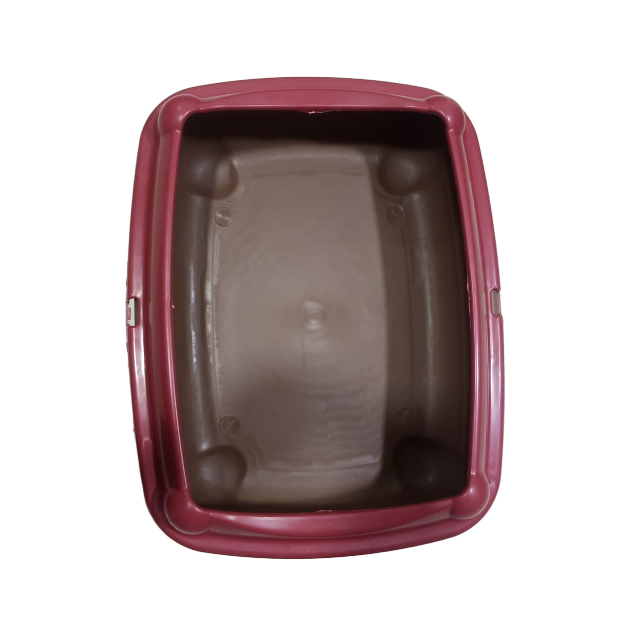 Brown pet carrier with a red rim on a tiled floor