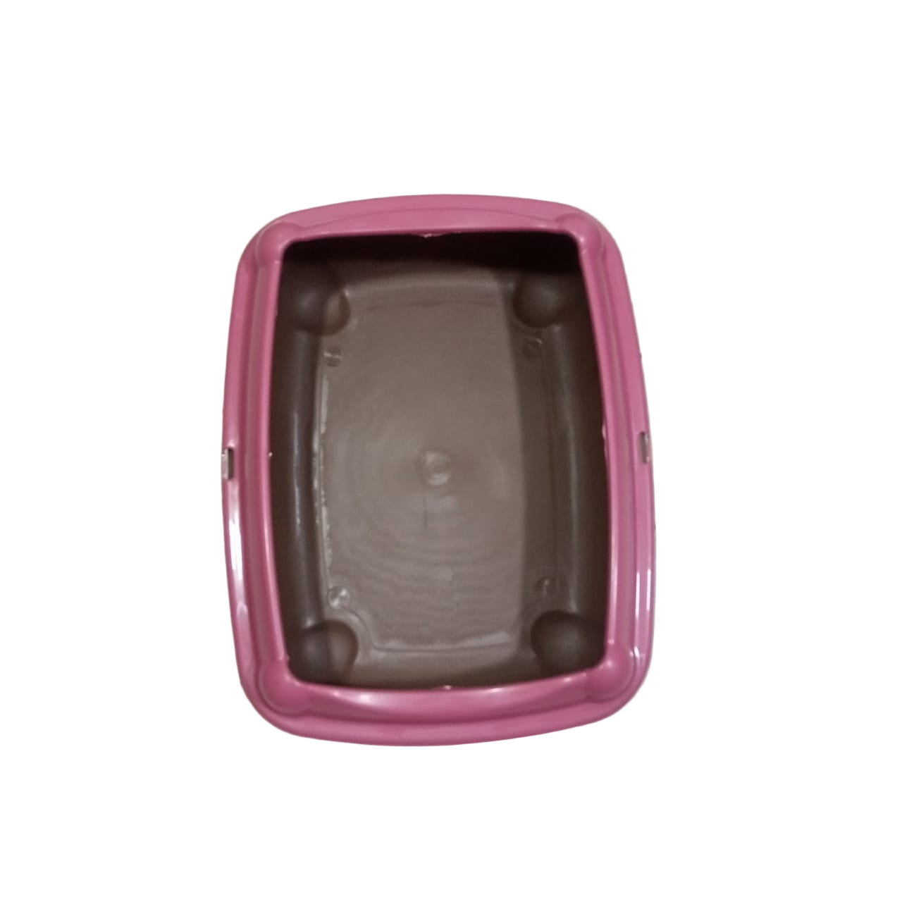 Pink pet litter box on a tiled floor