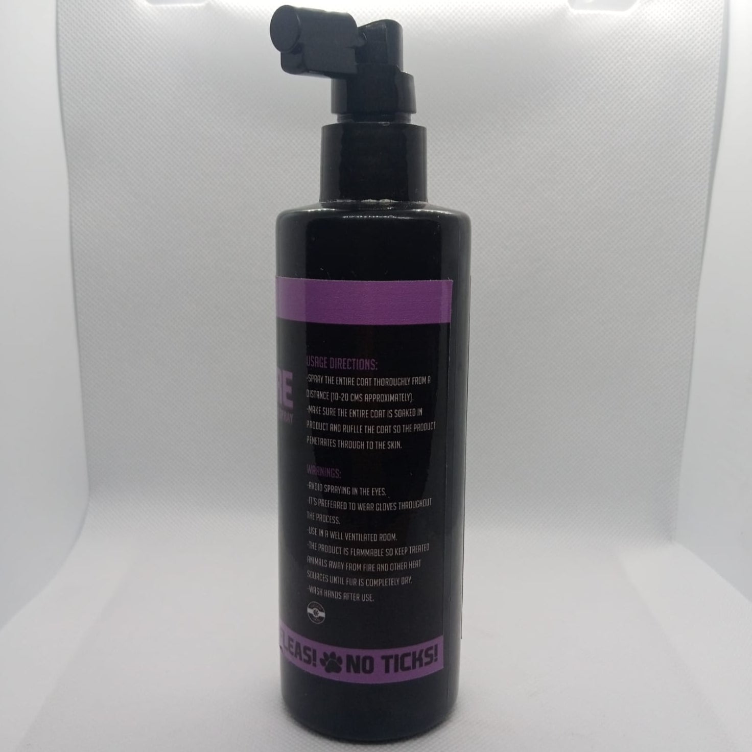 Black bottle with purple label on a white background
