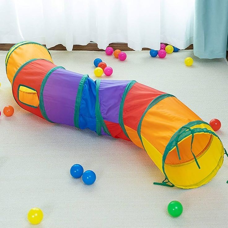 PetFriend cat tunnel toy in vibrant multicolored fabric with a zigzag design and scattered plastic play balls